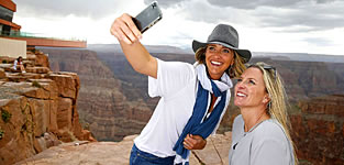Two women taking photographs at the West Rim of the Grand Canyon