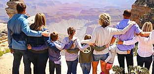 A family looking at the breathtaking views of the Grand Canyon's South Rim